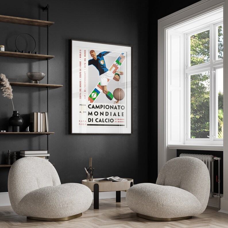 May include: A vintage poster featuring a graphic illustration of a football player in action. The poster is titled "Campionato Mondiale di Calcio" and includes the FIFA logo. The poster is framed and hanging on a black wall.