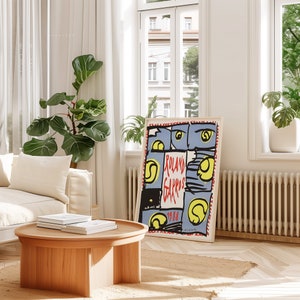 May include: A vintage poster with a blue background and red, yellow, and black abstract shapes. The text "Roland Garros 1988" is printed in red on the poster.