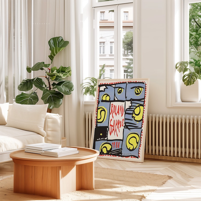 May include: A vintage poster with a blue background and red, yellow, and black abstract shapes. The text "Roland Garros 1988" is printed in red on the poster.