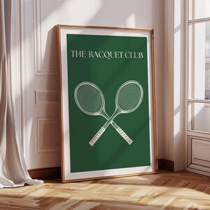 May include: A green poster with the text "THE RACQUET CLUB" in white lettering. Two white tennis rackets are crossed in the center of the poster.