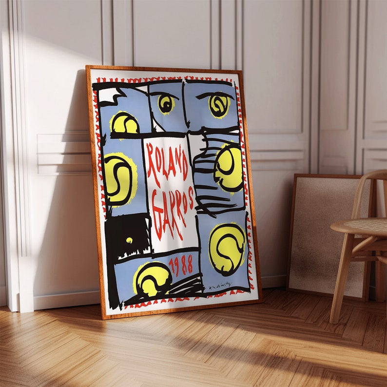 May include: A vintage poster for the 1988 Roland Garros tennis tournament. The poster features a blue and white background with a red and white border. The text "Roland Garros 1988" is written in red letters. There are several tennis balls depicted on the poster.