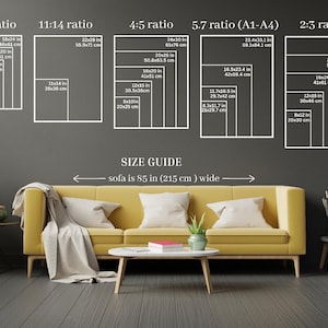 May include: A size guide for artwork, showing different aspect ratios and corresponding dimensions in inches and centimeters. The guide is displayed on a gray wall with a yellow sofa and a coffee table in front of it. The text "sofa is 85 in (215 cm) wide" is written below the guide.