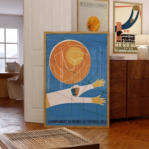 May include: A vintage poster with a blue background and a stylised illustration of a football player catching a large orange football in a net. The poster reads "Championnat du Monde de Football 1954".