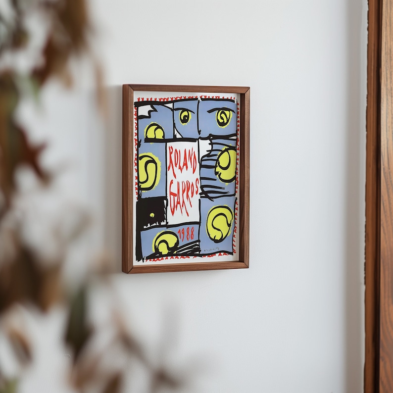 May include: A framed poster with a colorful abstract design featuring tennis balls and the text "Roland Garros 1988".
