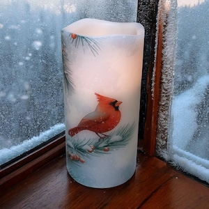 Red Cardinal in winter, real wax flameless candle, vibrant Cardinal on evergreen branch, LED, for all winter long, 3"x6", built in timer.