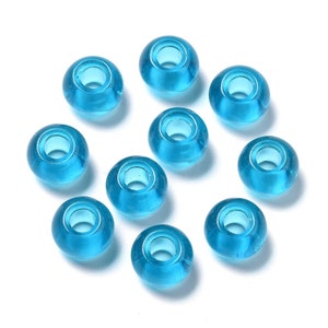 May include: A collection of ten translucent, round beads in a vibrant turquoise hue. Each bead has a central hole, creating a donut-like shape. The beads are evenly spaced against a white background, ideal for jewelry making or crafting.