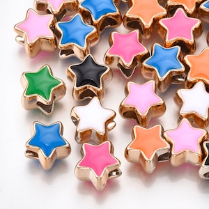 May include: Close-up of star-shaped beads in various colors, including pink, blue, green, and orange. Each bead has a gold-colored metal frame. These beads are ideal for jewelry making and crafting projects.