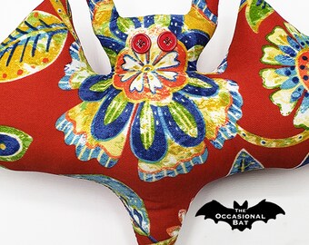 Red Bat Pillow with a Floral Pattern