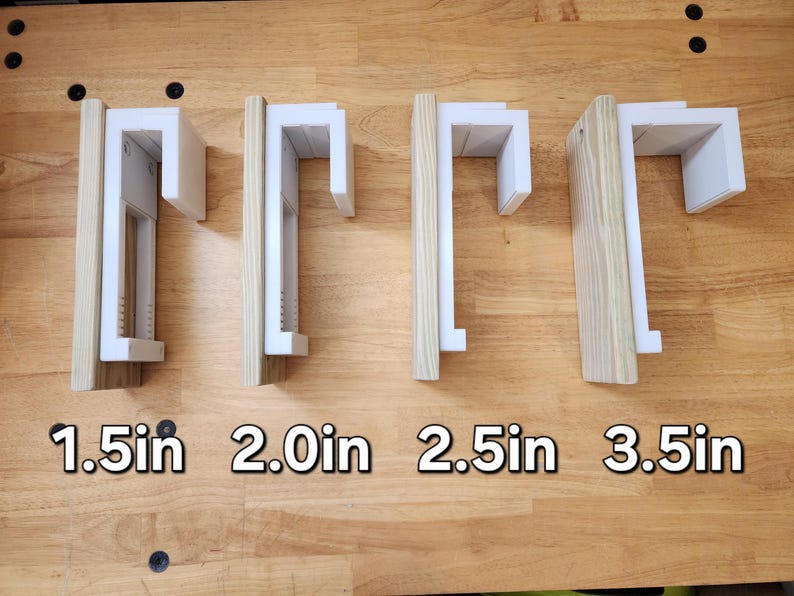 May include: Four white shelf brackets with different lengths: 1.5 in, 2.0 in, 2.5 in, and 3.5 in. The brackets are mounted on a wooden surface.