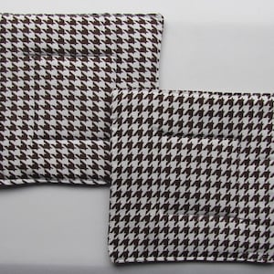 May include: Two brown and white patterned pot holders with a quilted design.