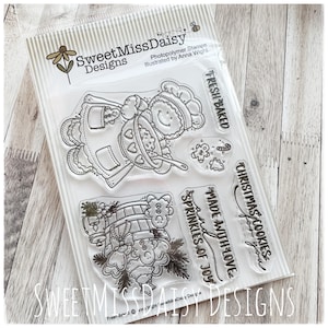 May include: A clear photopolymer stamp set by Sweet Miss Daisy Designs featuring illustrations of a gingerbread person baking, a basket of cookies, and text that reads FRESH BAKED, MADE WITH LOVE AND SPRINKLES OF JOY, and CHRISTMAS COOKIES FOR YOU.