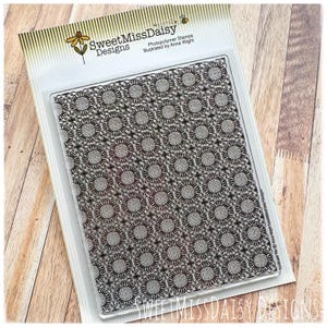 May include: Clear photopolymer stamp with a repeating floral pattern. The stamp is in a clear plastic package with the text "SweetMissDaisy Designs" and "Photopolymer Stamps illustrated by Anna Wight". The floral design is a series of circles with detailed inner patterns.