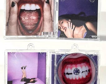 May include: Clear plastic CD case with four images. The images include a mouth with red lipstick, a woman with long dark hair, and a person lying on a bed. The CD has a mouth graphic.