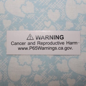 Pode incluir: Um r&oacute;tulo de advert&ecirc;ncia branco com um tri&acirc;ngulo preto contendo um ponto de exclama&ccedil;&atilde;o. O texto diz "AVISO C&acirc;ncer e danos reprodutivos - www.P65Warnings.ca.gov."