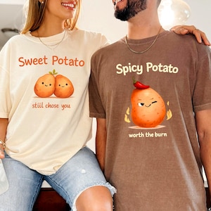Puede incluir: Dos camisetas a juego, una crema y otra marrón, con gráficos de patatas. La camiseta crema dice "Sweet Potato" con dos ilustraciones de patatas sonrientes y el texto "stiii chose you". La camiseta marrón dice "Spicy Potato" con un gráfico de patata y el texto "worth the burn".
