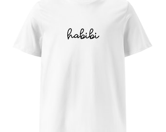 May include: White t-shirt with the word "habibi" written in black cursive script.