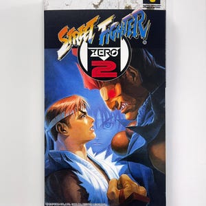 Street Fighter Zero 2 SFC Nieuw gemaakte kartonnen doos. Het is een lege doos. en heeft een cartridgehouder. En transparant huisdierenschild.