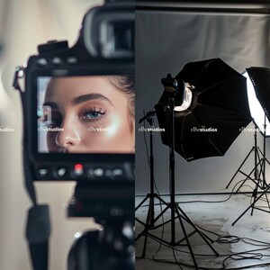May include: A camera is pointed at a person's face, capturing a close-up shot. The camera is set up in a studio with professional lighting equipment, including two large softboxes on tripods.