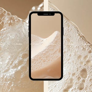 May include: A close-up of a smartphone displaying a beige background with white bubbles. The phone is surrounded by a white foamy substance.