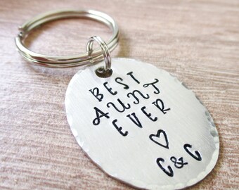 May include: Silver key chain with a round tag that says "Best Aunt Ever" with a heart and "C&C" on it.