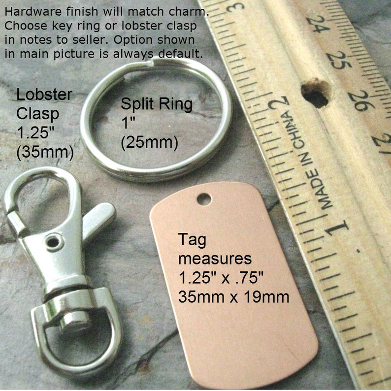 May include: A close-up of a silver lobster clasp and a silver split ring, both measuring 1.25 inches (35 mm) and 1 inch (25 mm) respectively. A copper-colored tag with the text "Tag measures 1.25" x .75" 35mm x 19mm" is shown next to a ruler.
