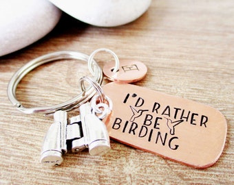 May include: Copper keychain with a silver charm of binoculars and the text "I'd rather be birding" with two hummingbird silhouettes.