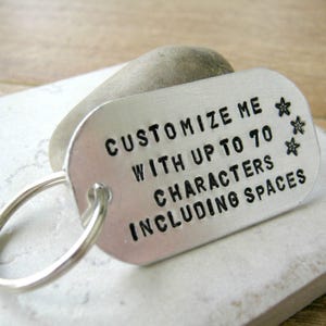May include: Silver keychain with a tag that says "Customize me with up to 70 characters including spaces".
