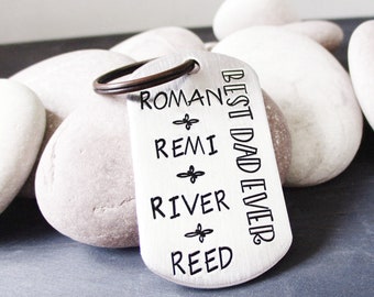 May include: Silver keychain with the text "Best Dad Ever" and the names Roman, Remi, River, and Reed engraved on it.