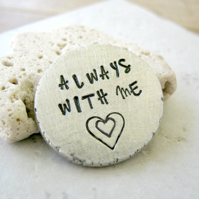 May include: A silver metal disc with the words "ALWAYS WITH # ME" engraved on it. A double heart design is engraved below the text.