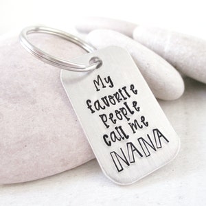 May include: Silver keychain with a rectangular tag that reads "My favorite people call me NANA".