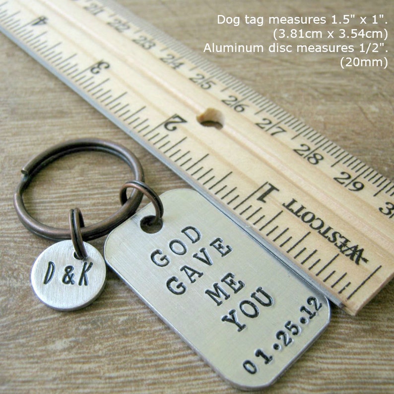 May include: A silver keychain with a tag that reads "God Gave Me You" and a smaller tag that reads "D&K". The keychain is 1.5 inches by 1 inch and the smaller tag is 1/2 inch in diameter.