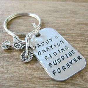 May include: Silver keychain with a small motorcycle charm and a tag that reads "Daddy & Grayson Riding Buddies Forever".