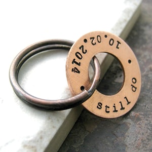 May include: Copper keychain with a round tag that says "still do 10.02.2014".