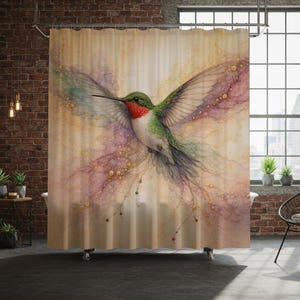 May include: A shower curtain featuring a watercolor painting of a hummingbird in flight. The bird has green, red, and white feathers, with outstretched wings. The background is a soft blend of colors, including gold, purple, and green.