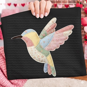 May include: A colorful hummingbird design on a black background. The bird is made of patchwork fabric in pastel colors, including pink, blue, yellow, and green, with floral and polka dot patterns. The background has a wavy pattern.
