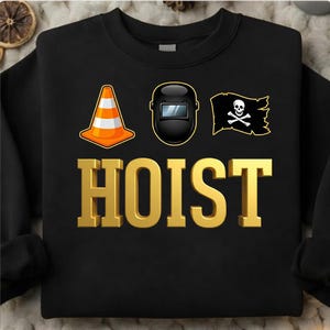 May include: Black sweatshirt with a gold "HOIST" text and three graphics: an orange and white traffic cone, a black welding mask, and a black pirate flag with a skull and crossbones. The sweatshirt is a crew neck.