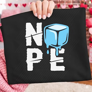 May include: Black graphic tee with the word "NOPE" in white, featuring a melting blue ice cube graphic. The design is centered on the shirt, with a diagonal line pattern in the background.