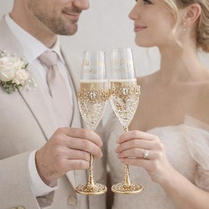 Personliga guldfärgade champagneglas och tårtset för bröllop