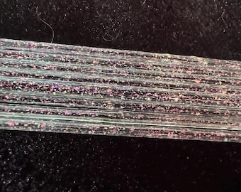 Magenta-Gold Dichroic Glass Stringers cased in Double Helix Zephyr clear COE 104