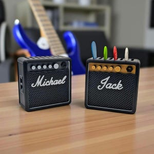 A pair of mini marshall guitar amplifier styled plectrum displays with colourful guitar picks nestled into the right   personalized mini amps adorned with "Michael" & "Jack"