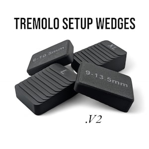 May include: Four black guitar setup wedges, labelled with different sizes: 6-10 mm, 9-13.5 mm, XL, and .V2. The wedges are designed to adjust the height of a guitar.