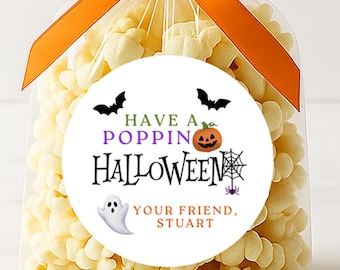 May include: A clear cellophane bag filled with popcorn, tied with an orange ribbon. A round sticker on the bag reads "Have a Popping Halloween" with bats, a jack-o'-lantern, a spiderweb, a ghost, and the text "Your Friend, Stuart."