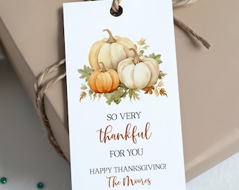 May include: A gift tag with a watercolor illustration of three pumpkins in shades of orange and white, with green leaves. The tag reads "So Very Thankful For You Happy Thanksgiving! The Moores."