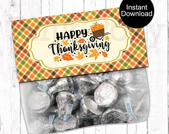 May include: A clear cellophane bag filled with silver-wrapped chocolate candies. The bag is topped with a decorative label featuring the words "HAPPY Thanksgiving" in black script, with fall leaves and a pumpkin cart design.
