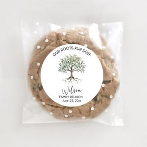 May include: A chocolate chip cookie in a clear cellophane bag with white polka dots. A round sticker on the cookie reads "OUR ROOTS RUN DEEP" with a tree illustration and the name "Wilson" and "FAMILY REUNION June 23, 20xx."