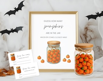 May include: A framed sign with the text "Guess how many pumpkins are in the jar". Two jars filled with orange pumpkins are displayed, along with small cards for guessing. Black bat decorations add a festive touch.