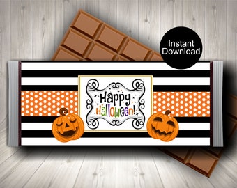 May include: A Halloween-themed candy bar wrapper with a black and white striped background, orange polka dot accents, and two carved pumpkin illustrations. The wrapper features the text "Happy Halloween!" and is accompanied by a chocolate bar.