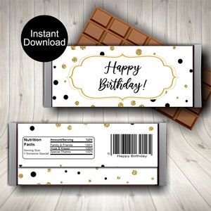 May include: A printable chocolate bar wrapper with a white background and black and gold polka dots. The wrapper has a gold frame with the text "Happy Birthday!" in black script. The bottom of the wrapper has a nutrition facts label with the text "Family & Friends, Hugs & Kisses, Special Thanks" and the text "Happy Birthday" at the bottom.