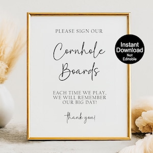May include: A rectangular sign in a thin gold frame with white background and black text that reads: PLEASE SIGN OUR Cornhole Boards EACH TIME WE PLAY, WE WILL REMEMBER OUR BIG DAY! thank you! A black circle with white text reads: Instant Download Not Editable.