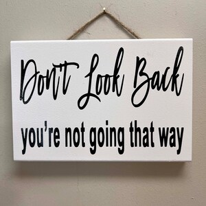 Don&#39;t look back You&#39;re not going that way sign